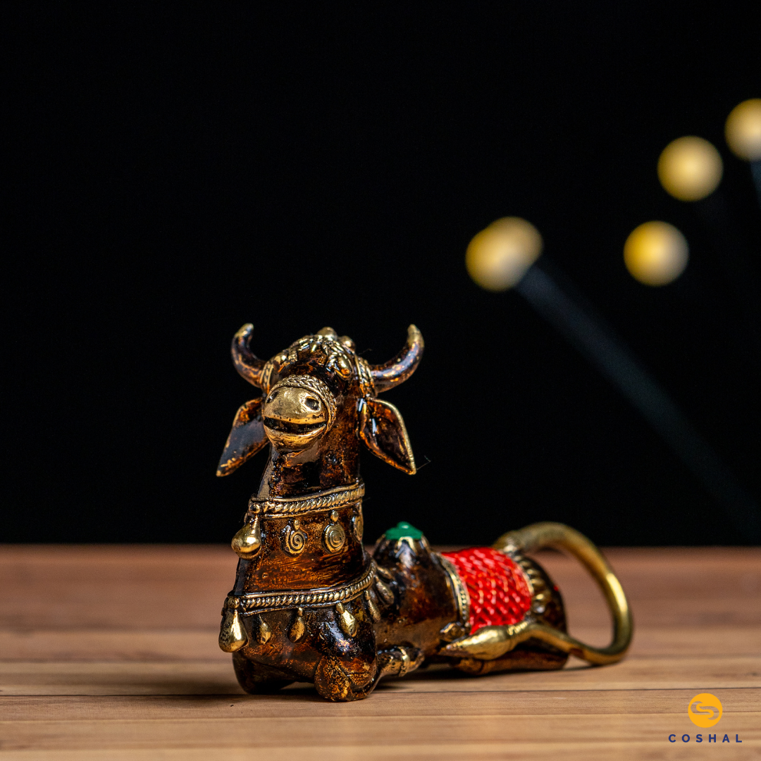 Nandi, the sacred bull and divine vehicle of Lord Shiva, is portrayed with intricate details and a timeless charm. The Dhokra technique, an age-old method of metal casting, brings out the fine nuances of this handmade masterpiece.