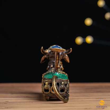 Dhokra Handcrafted Brass Nandi, the sacred bull, is intricately detailed using the ancient Dhokra technique—a method of non-ferrous metal casting practiced for centuries. The result is a stunning candle holder that not only radiates warm, flickering light but also pays homage to Indian heritage.