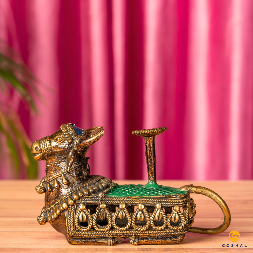 Nandi, the sacred bull, is intricately detailed using the ancient Dhokra technique—a method of non-ferrous metal casting practiced for centuries. stunning candle holder